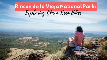 Woman sitting on a rocky hilltop overlooking the vast landscape of Rincon de la Vieja National Park in Costa Rica