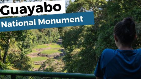 Visitor observing ancient ruins at Guayabo National Monument in Costa Rica